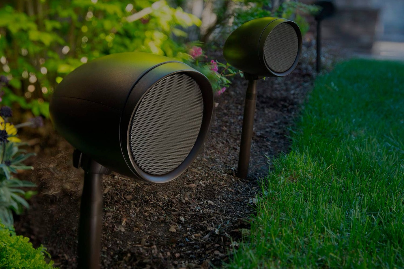 Landscape speakers in a garden bed