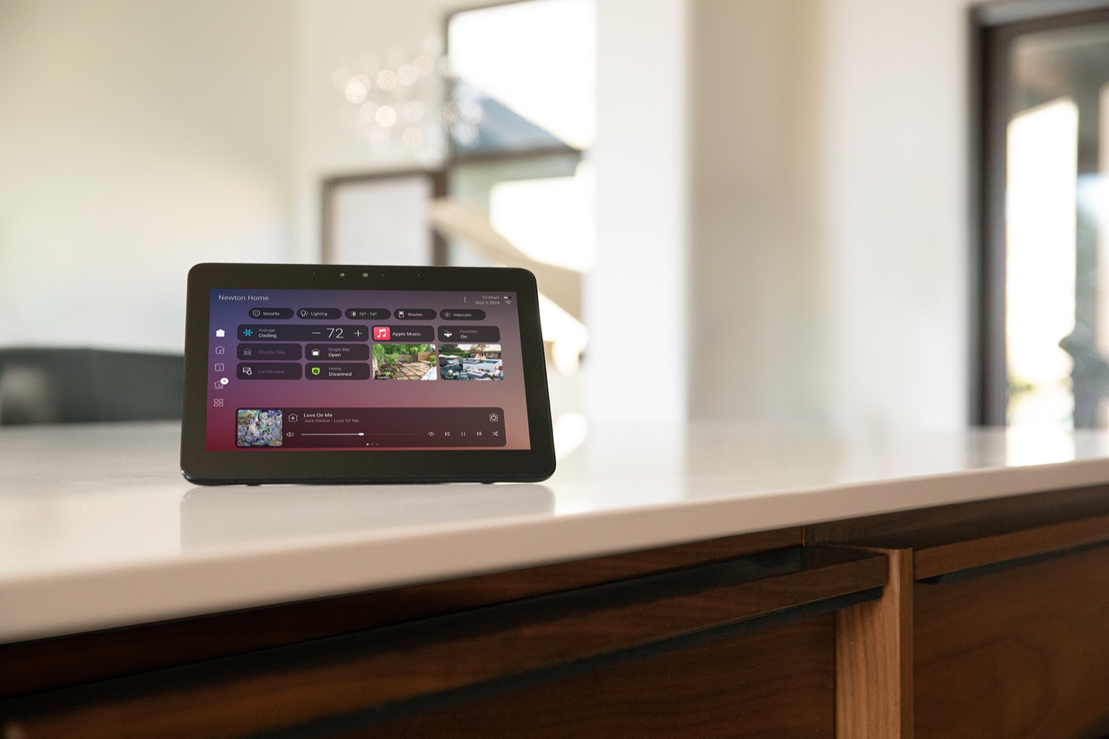 A Control4 touchscreen showing the X4 home screen on a kitchen counter
