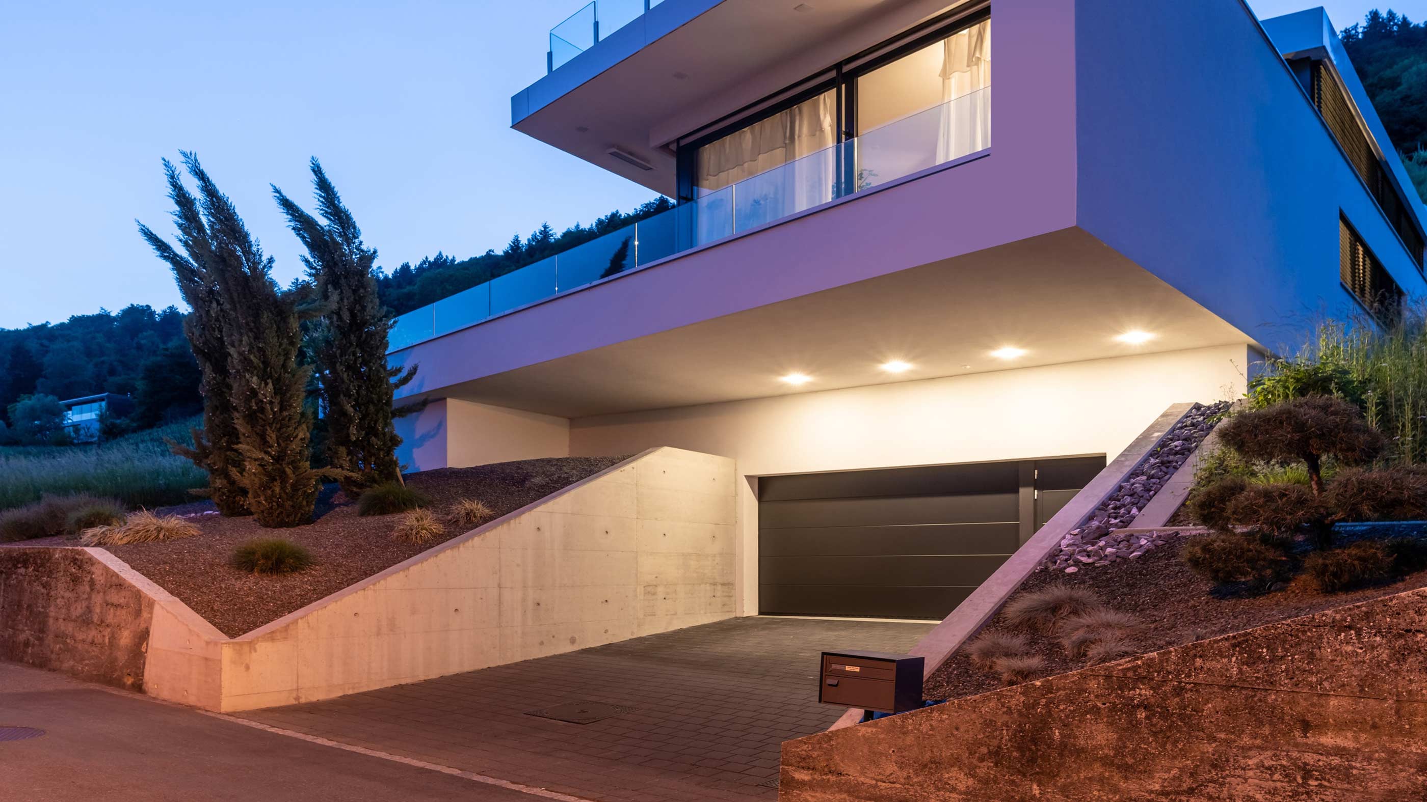 Finished garage with even overhead lighting and a wall-mounted display
