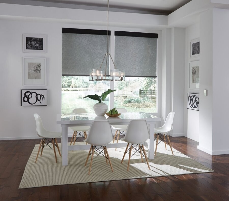 A dining space featuring motorized window treatments.