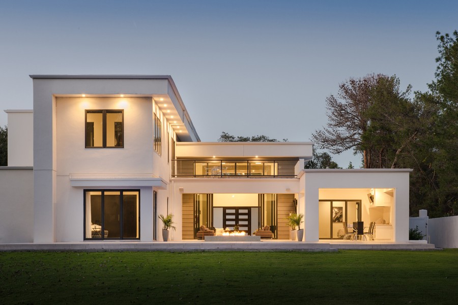 an exterior view of a well-lit home at night 