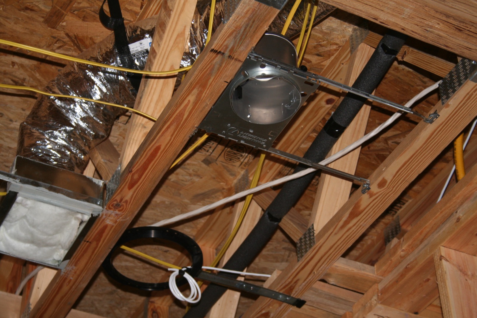 Coiled home-run cabling at a wall opening