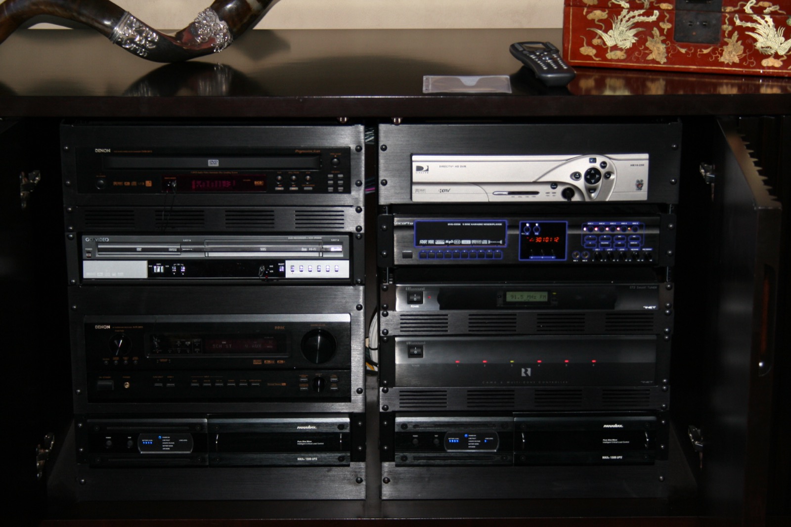 Rack-mounted audio and video components concealed in a custom media cabinet