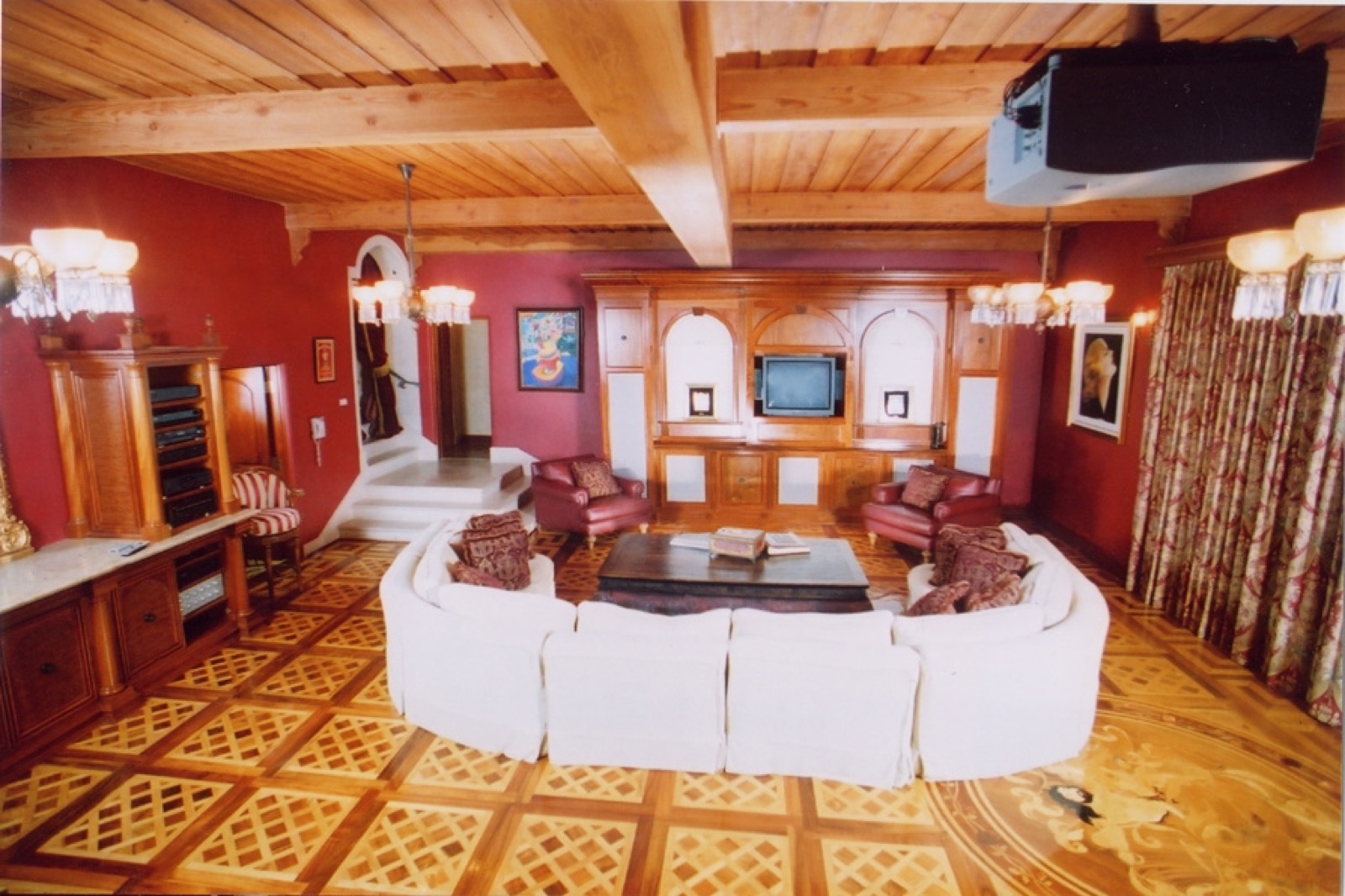 Early project great room theater with a ceiling projector and hidden drop-down screen
