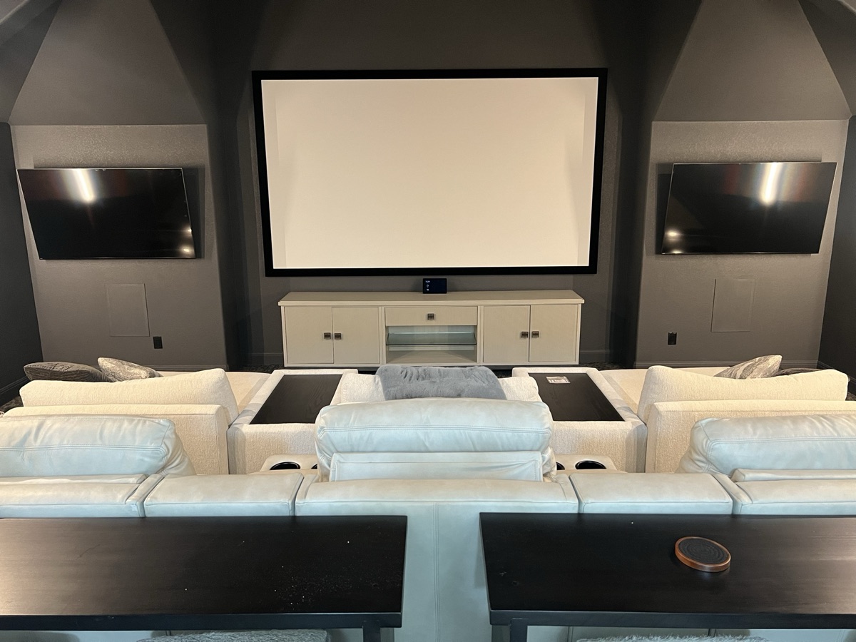 Kingsland grand theater with a 165-inch screen, flanking TVs, and tiered seating