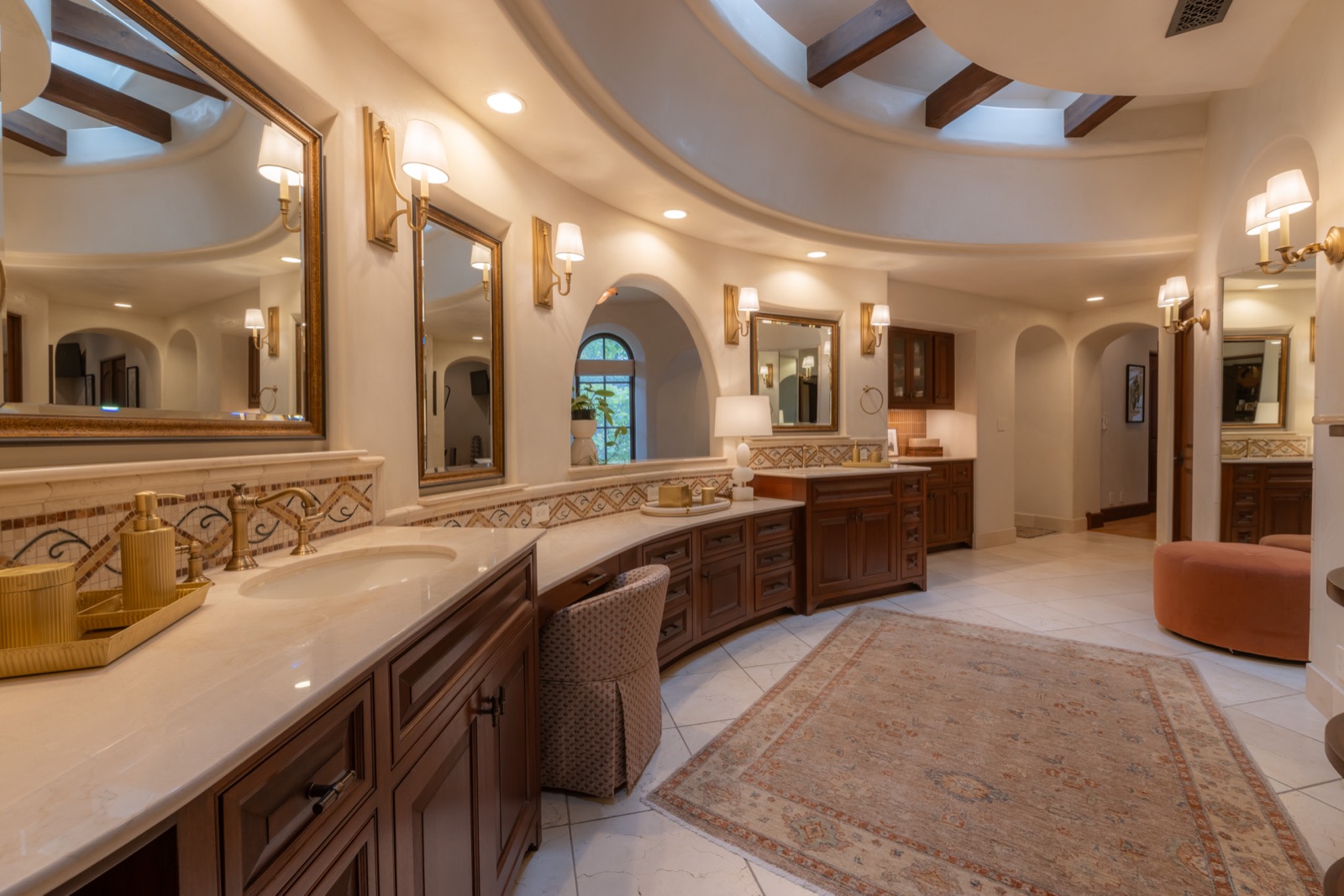 Master bath with sconce lighting under an oval tray ceiling