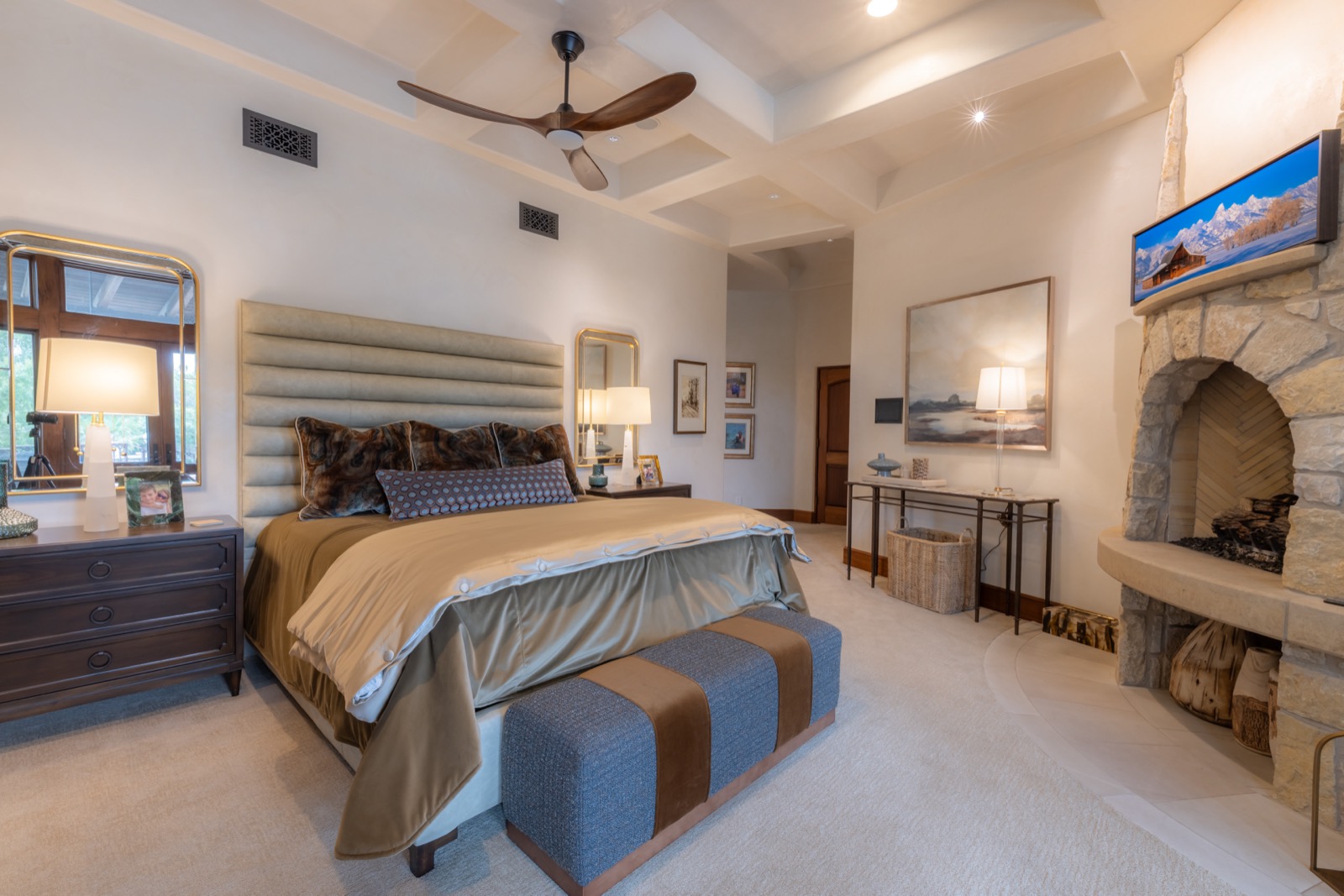 Master bedroom with a TV above the corner fireplace