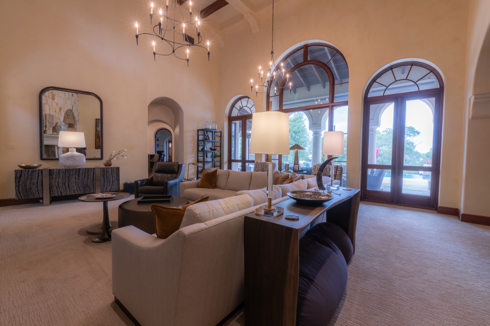 Sitting room with layered lamp light and arched windows