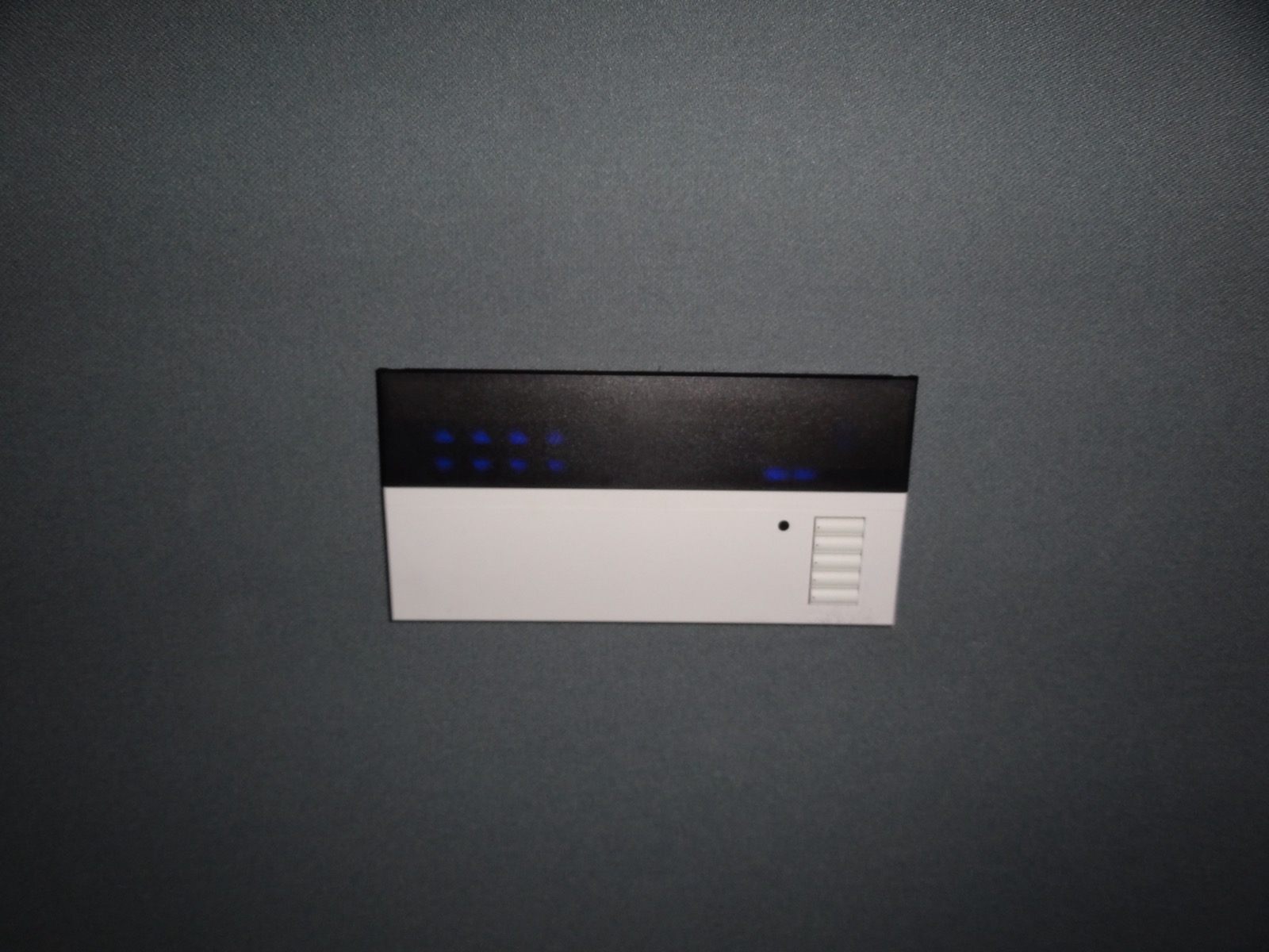 Wall-mounted Lutron lighting keypad in the fabric-walled Tarrytown theater