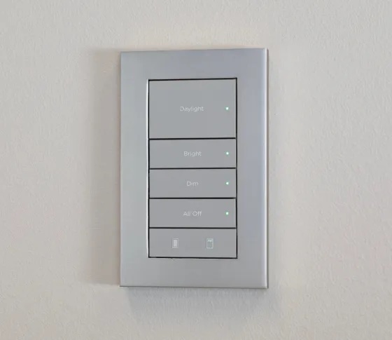 Control4 Lux keypad with engraved Daylight, Bright, and Dim buttons on a brushed metal faceplate