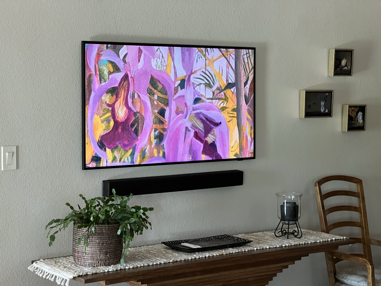 A Frame display showing art above a soundbar and console table in the living room