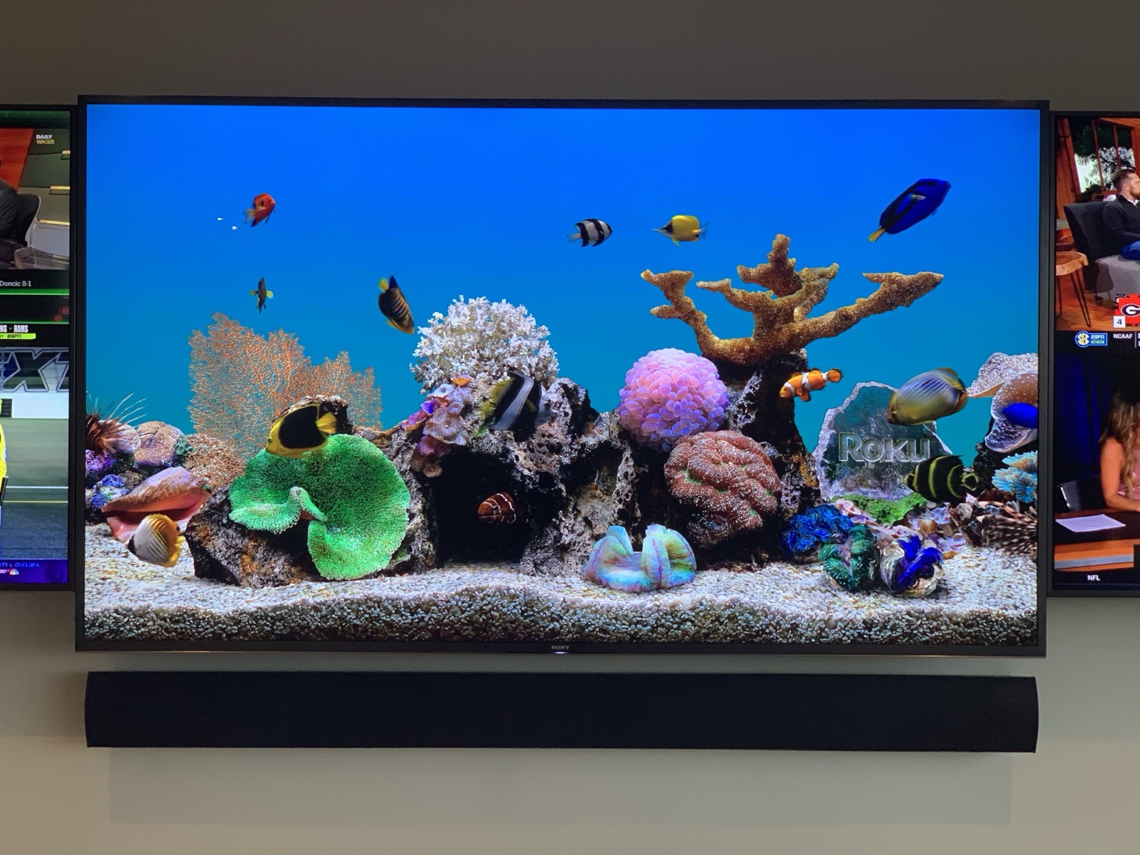 The center display above the custom passive Triad soundbar, built to match its width