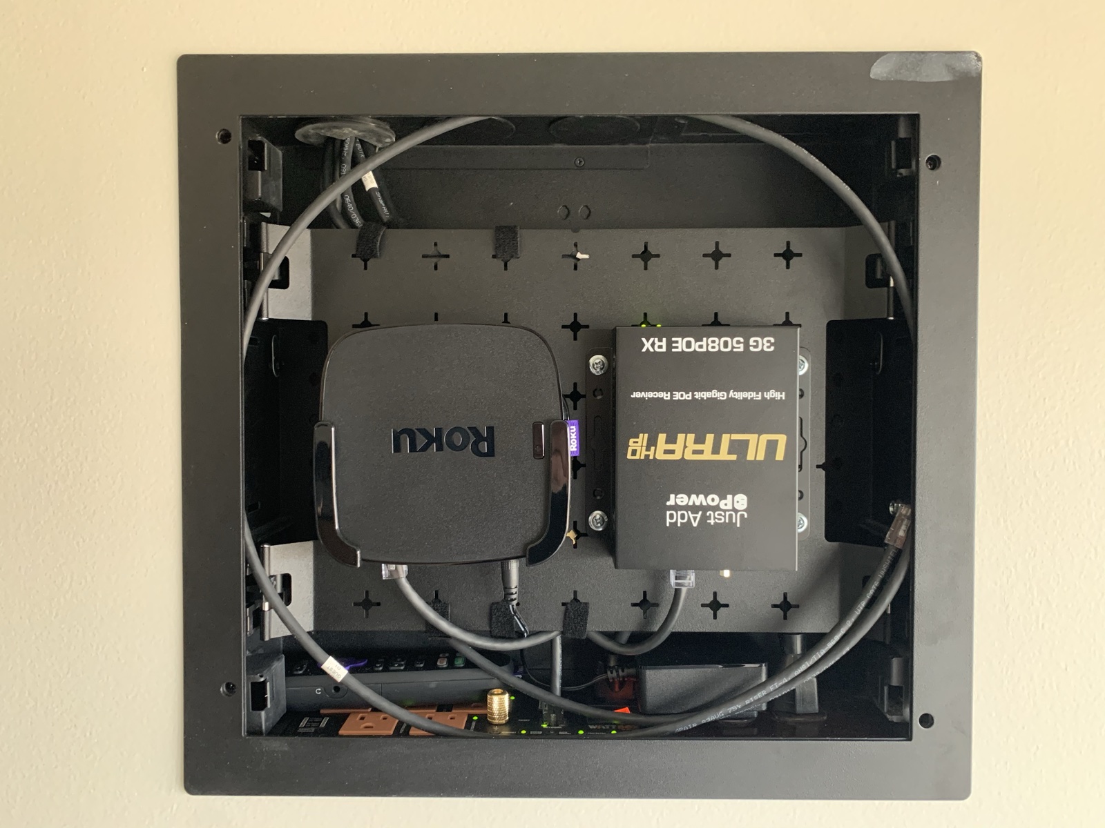 Inside the in-wall box behind a display: a Roku streamer and a Just Add Power receiver
