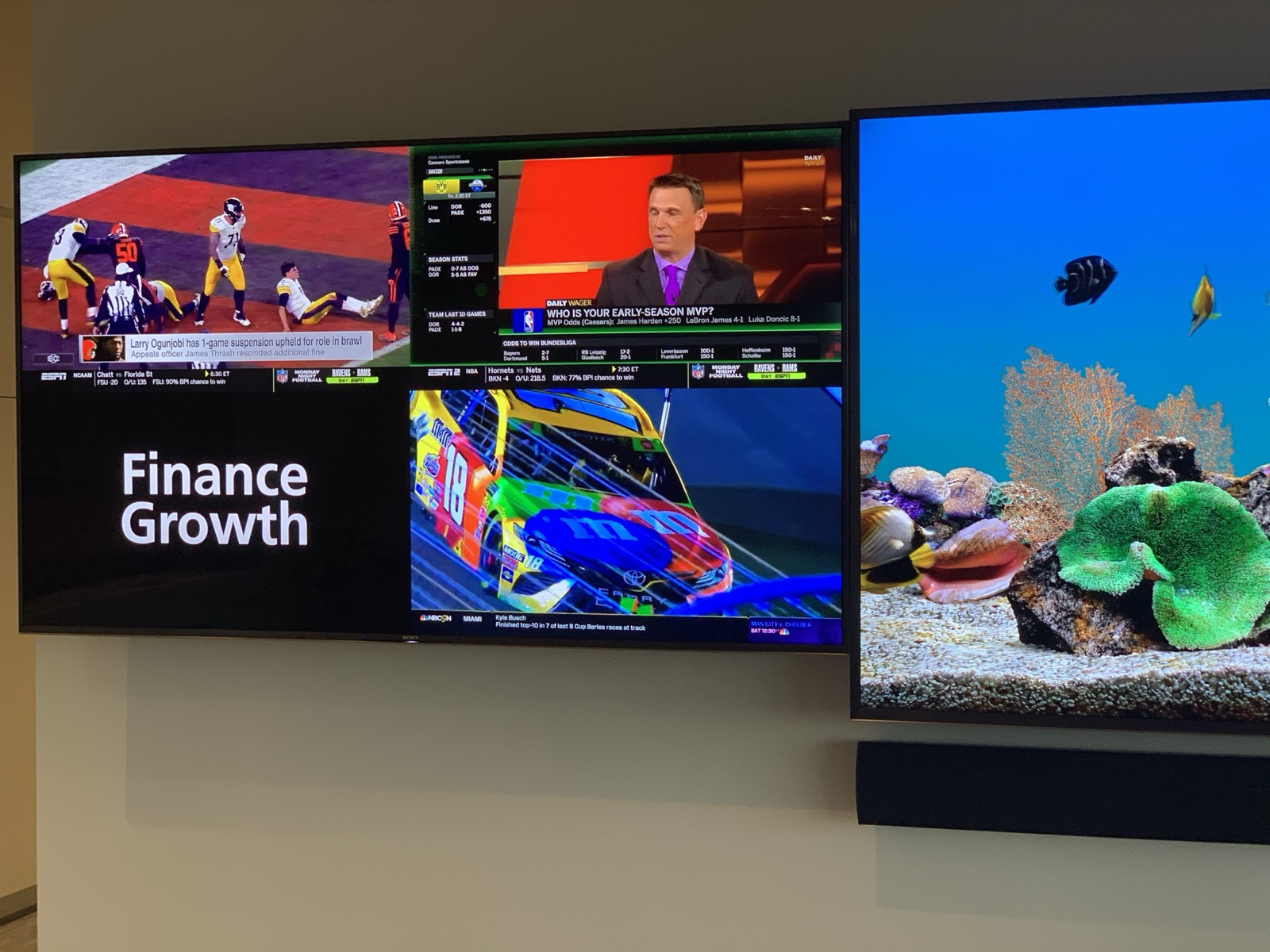 The left display of the video wall tiling four programs at once, beside the center screen
