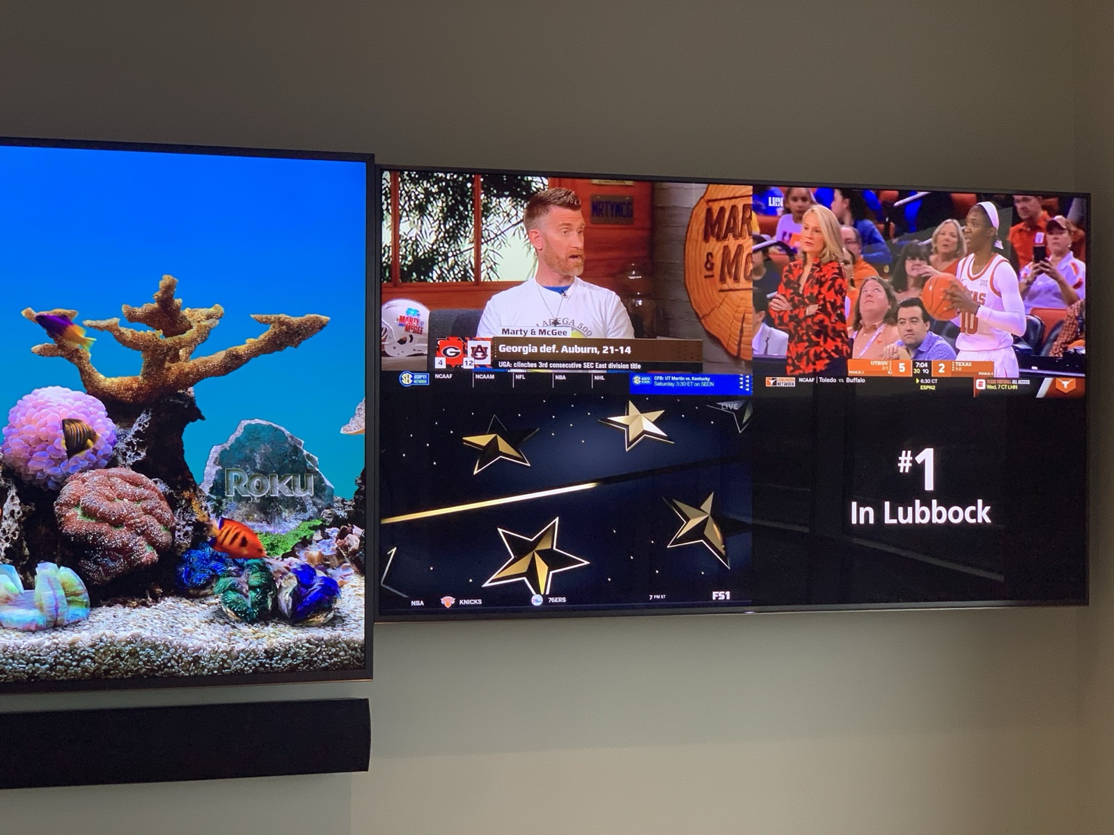 The right display of the video wall tiling four programs at once, beside the center screen