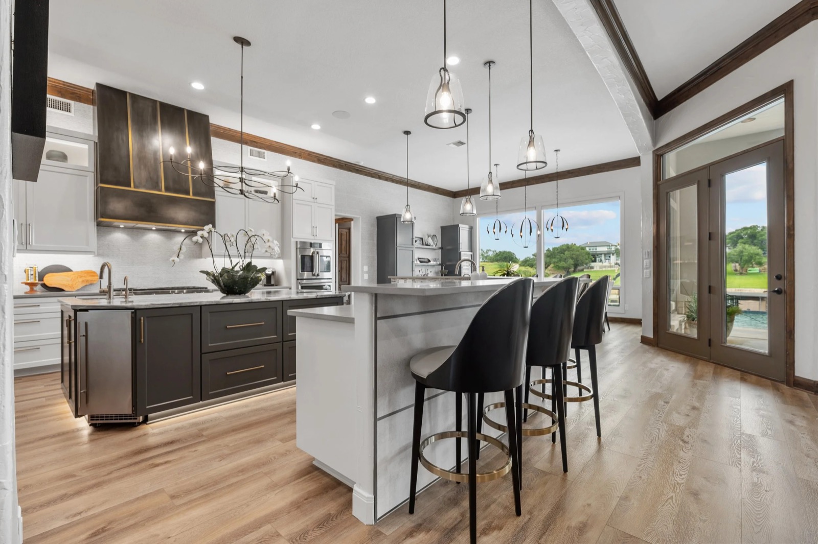 Kingsland kitchen with a large island, bar seating, and windows to the grounds beyond
