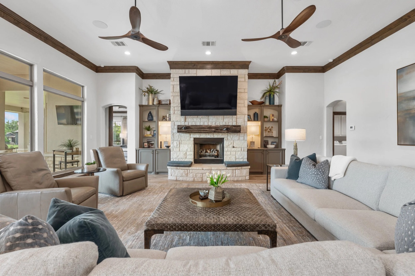Living room with the 85-inch display above the stone fireplace