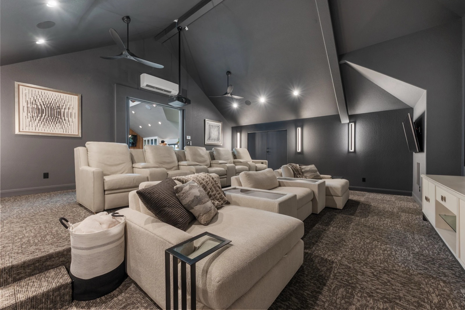 Kingsland home theater seating seen wide, with sectional rows in front and leather recliners on the raised tier behind