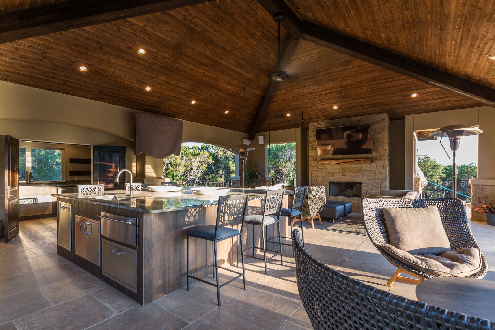 Outdoor cabana kitchen and living area at a Lake Travis home