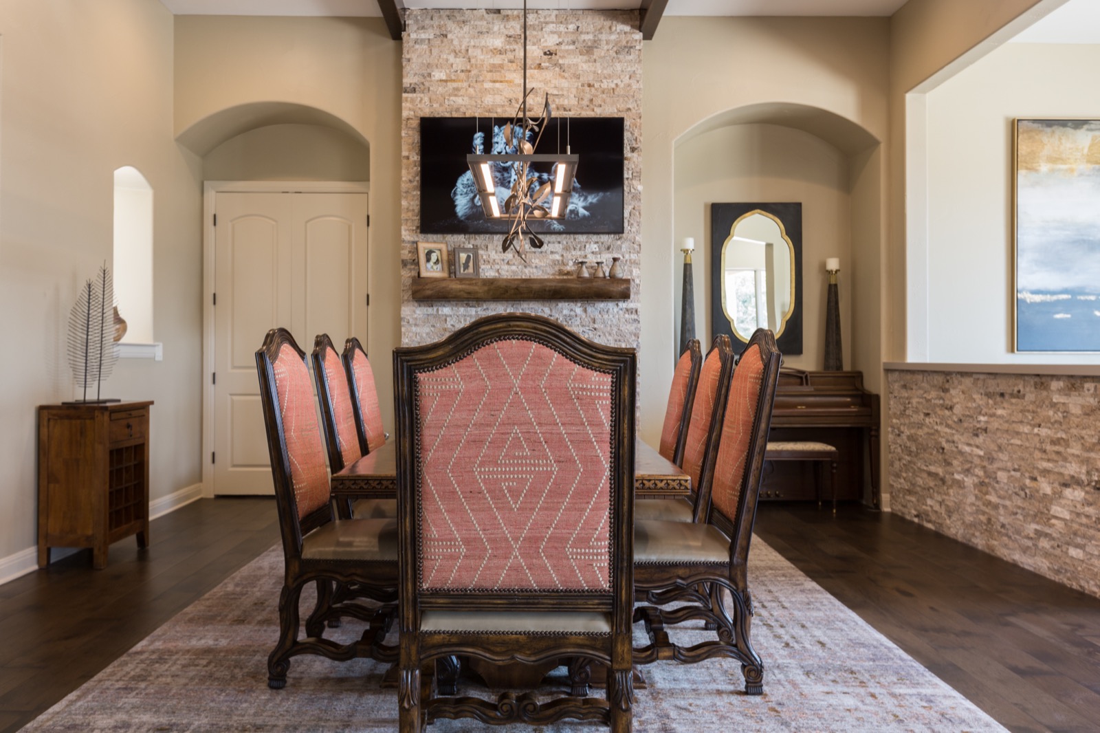 Frame display showing art above the dining room fireplace
