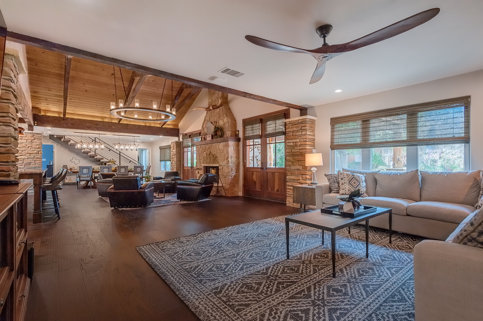The open living area at the Marble Falls retreat with a ceiling-mounted Wi-Fi access point under the vaulted wood ceiling