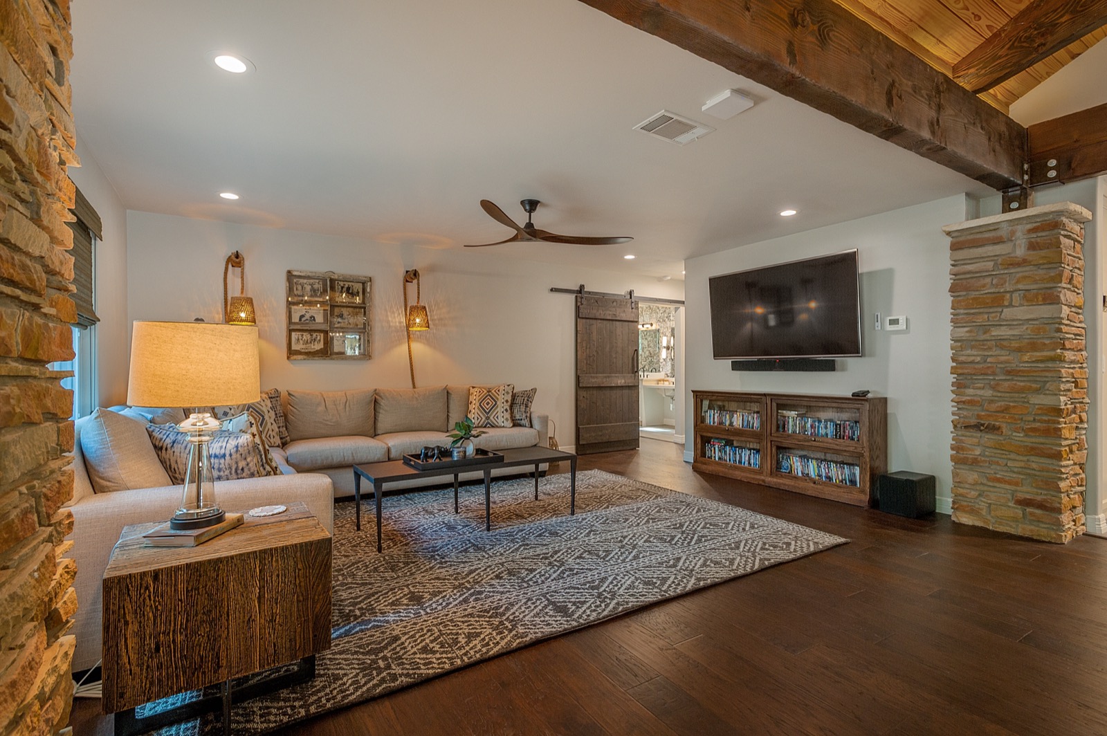 Family sitting room with wall-mounted TV and soundbar, wired and installed by Bennett Technologies
