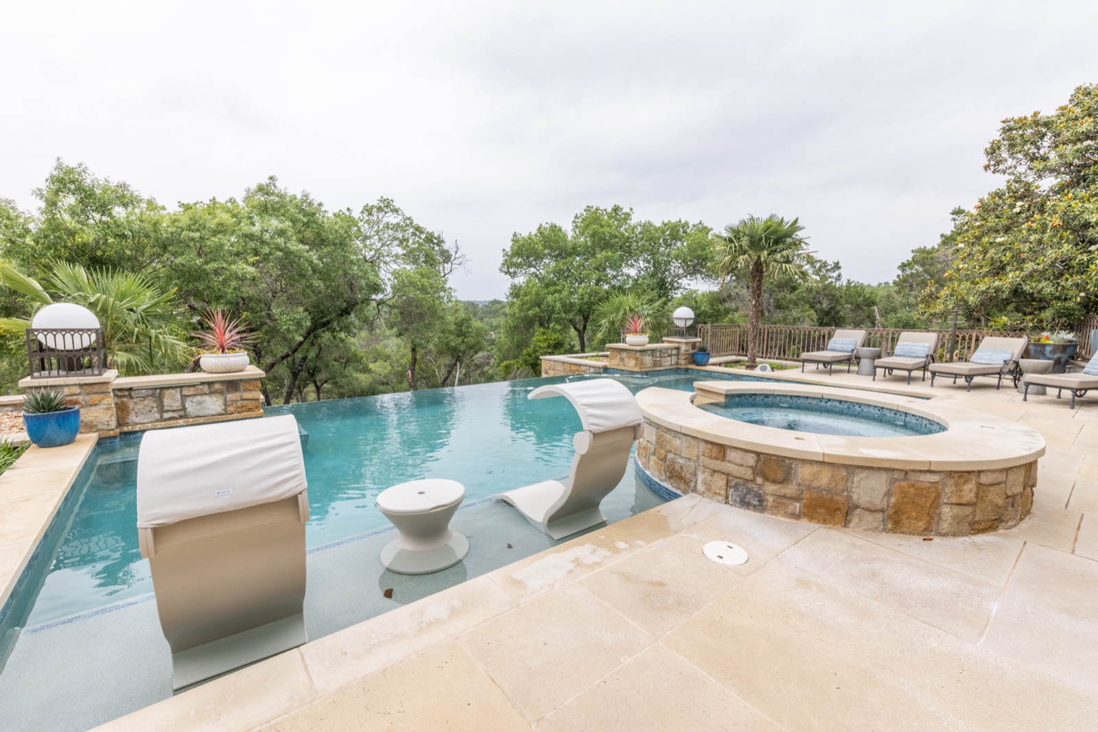 The pool and raised spa outside the Northwest Austin home, overlooking the hill country