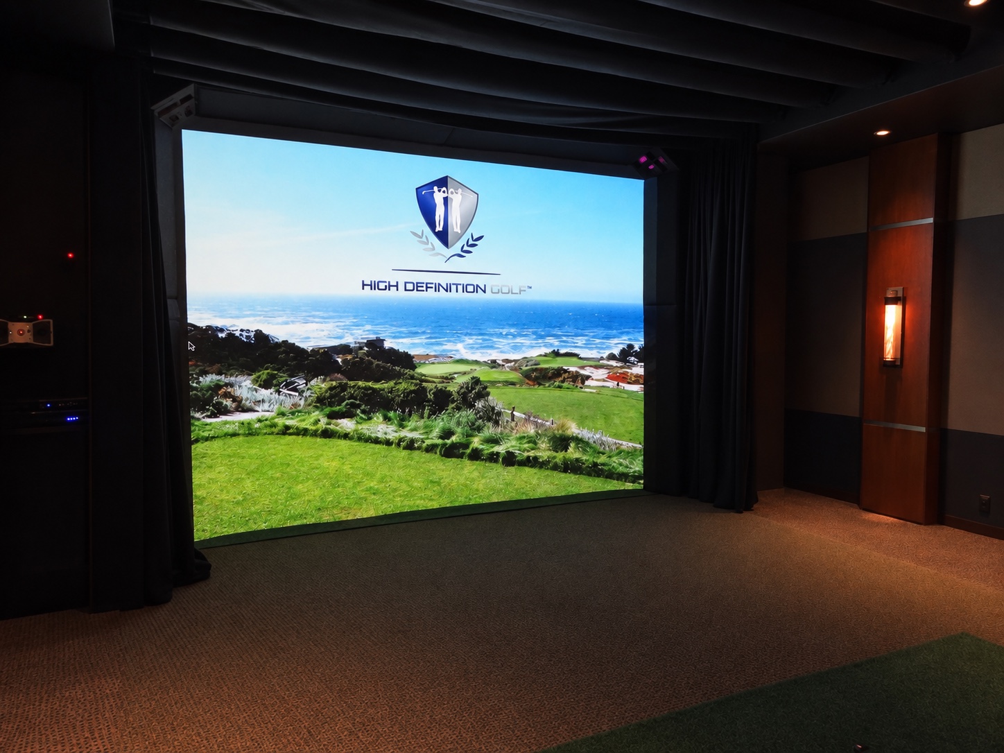 Golf simulator screen and turf in the Tarrytown entertainment pavilion