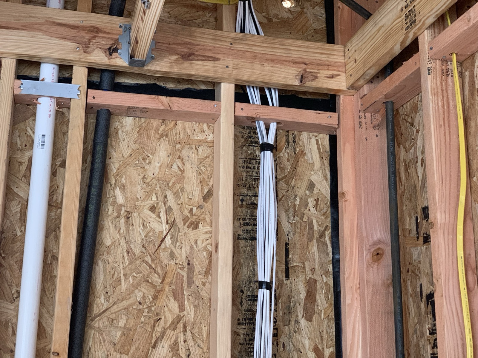 Loomed structured wiring bundle running through open wall framing