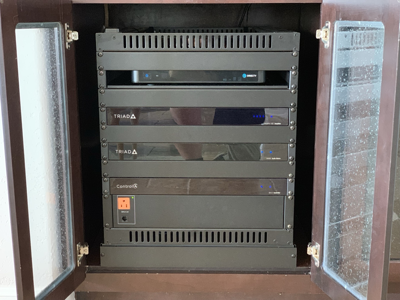 Equipment cabinet with Triad amplifiers and a Control4 controller