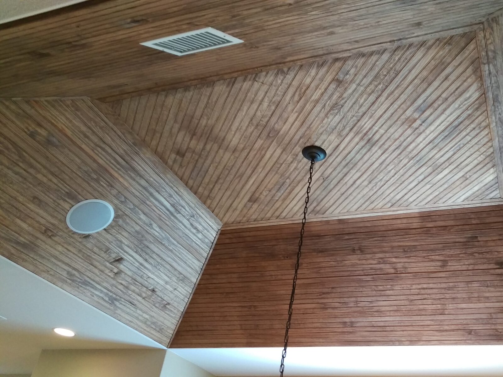 In-ceiling speakers set into a wood tray ceiling by Bennett Technologies
