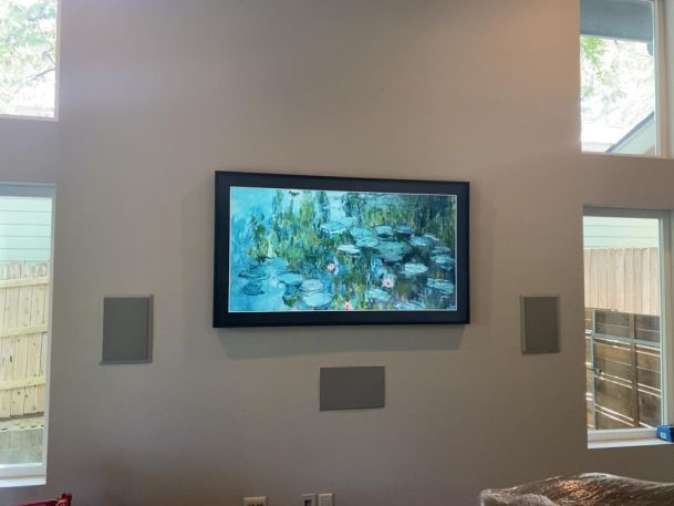TV on wall with speakers