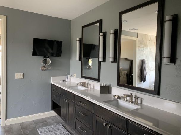 bathroom with tv on grey wall
